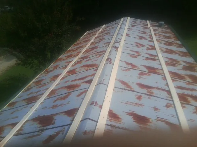 Rusted metal roof panels with new wood purlins before replacement — Storm Damage Roof Repair in Rowesville by Roofing Brothers