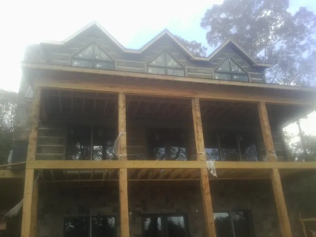 Dormers and porch framing on a large log home under construction in Rowesville